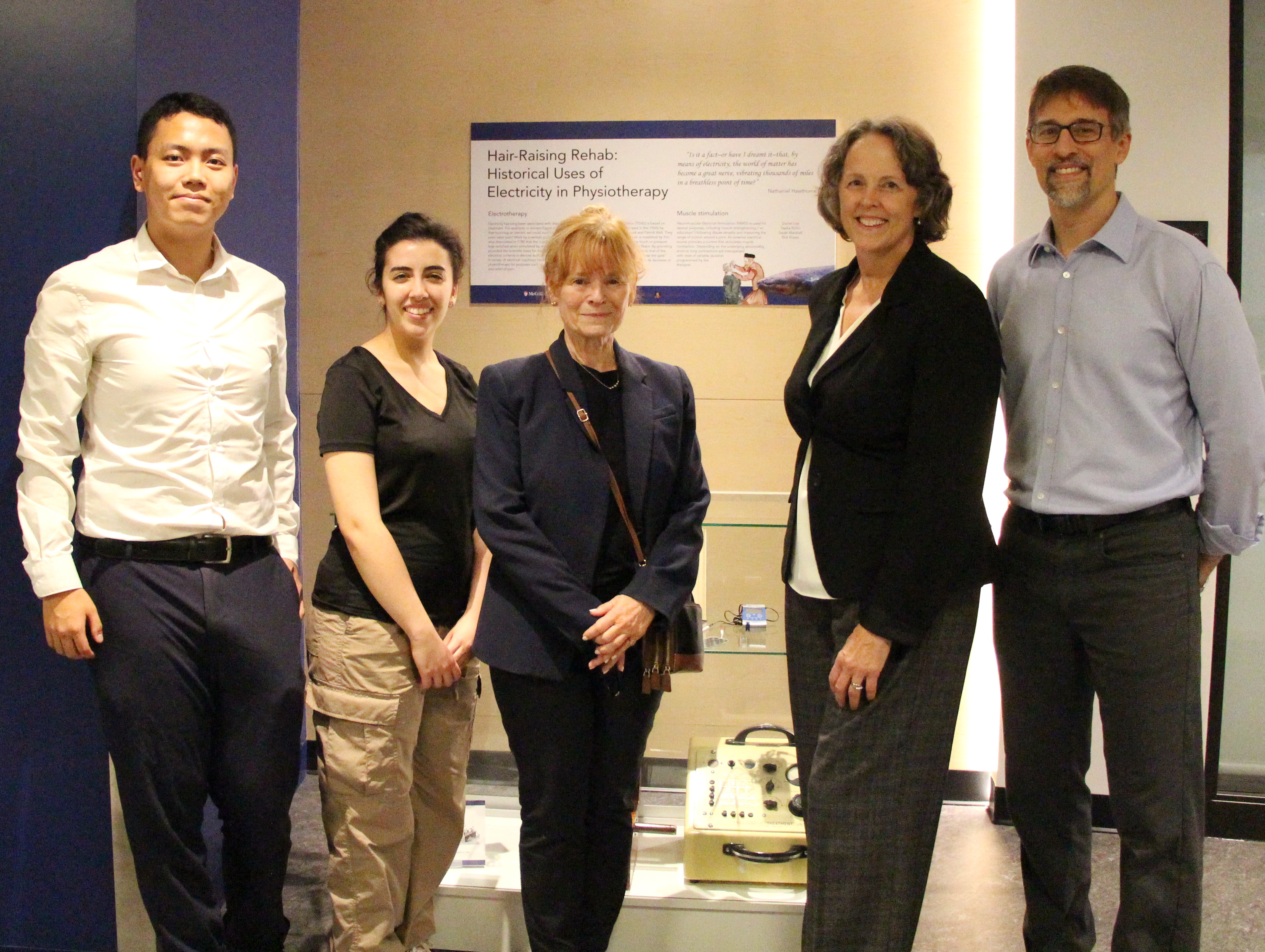 Group of People standing in front of the display case. 