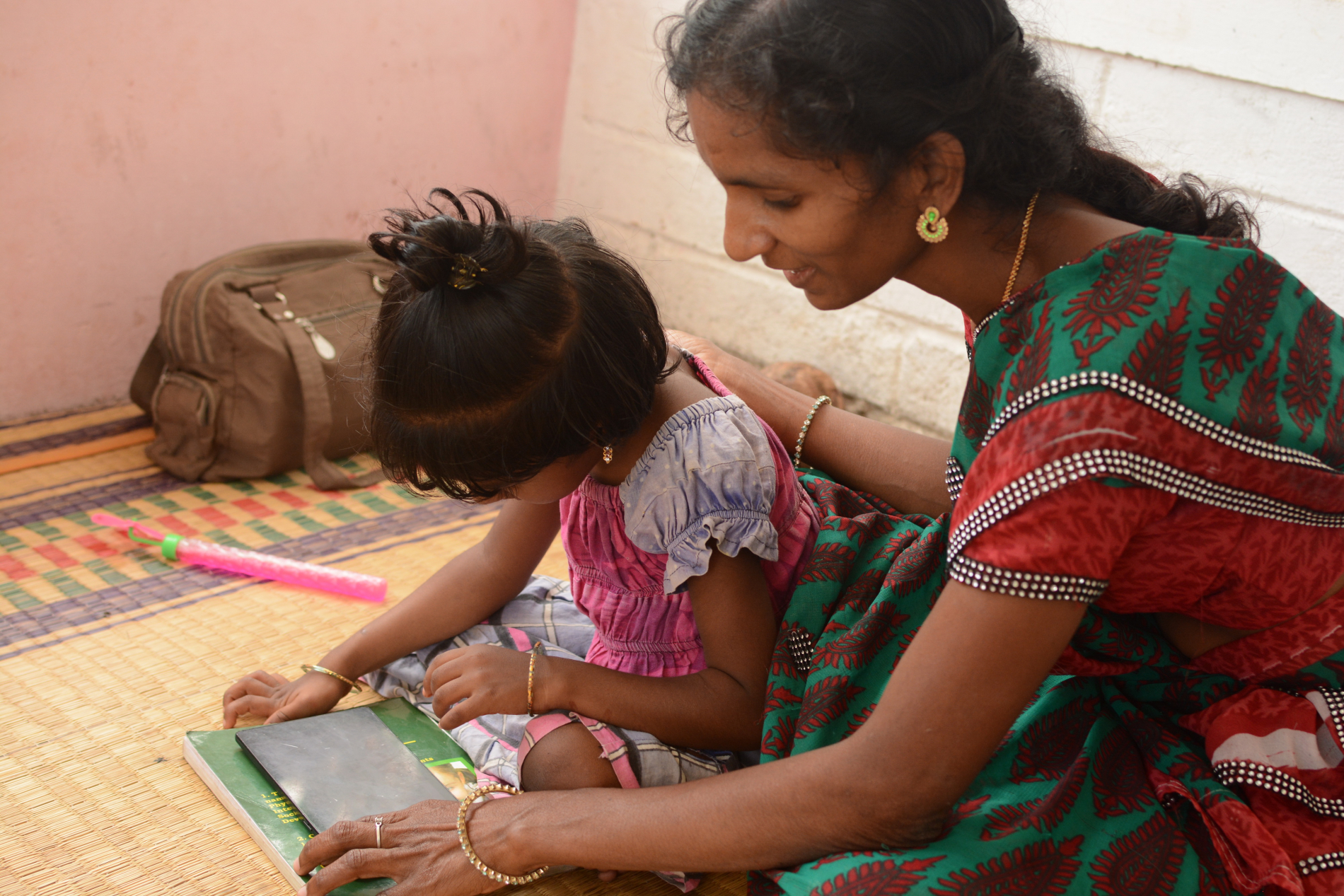 Health Care Professional helping child with ipad 