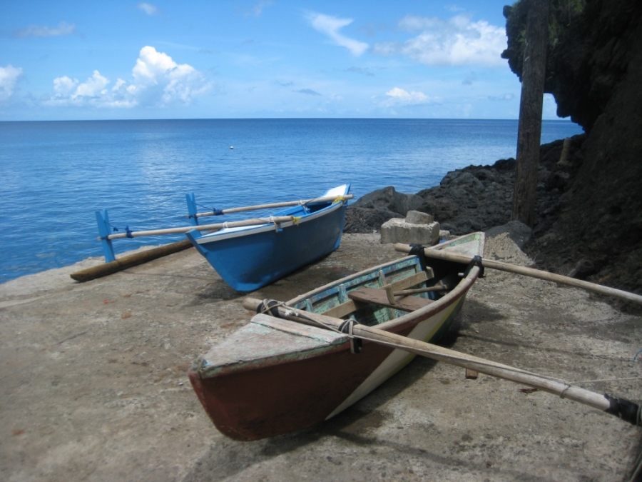Hand-made wooden outrigger canoes on the village quai