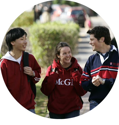 Three students wearing McGill sweaters walking on campus