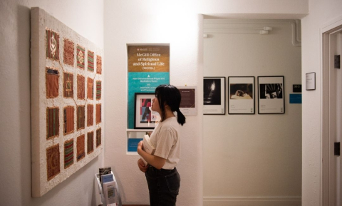 A student observes a painting on the wall at the McGill Office of Religious & Spiritual Life