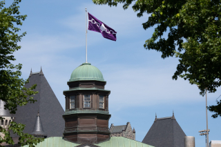 Hiawatha Wampum Belt flag flying from the McCall MacBain Arts Building to mark National Indigenous Peoples Day 