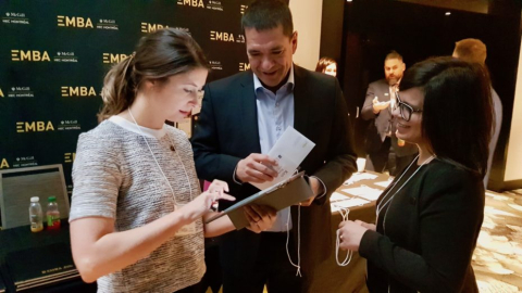 Christa Grant, Executive MBA program administrator (left), uses the new Mc3Gill Carbon Calculator to find out the emissions generated by EMBA alumnus Ken Rock (centre) and Elizabeth Branco, International Masters for Healthcare Leadership & Management program administrator (right), as they traveled to the event.
