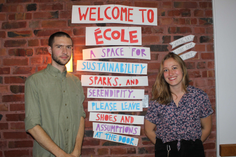 An image of students standing next to an ECOLE sign