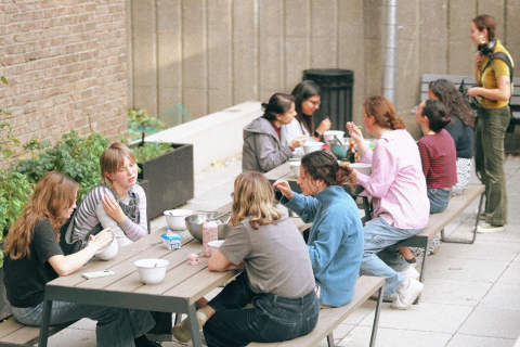 An image of students sharing lunch in an outdoor setting