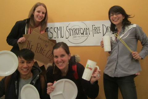 An image of students holding dishware