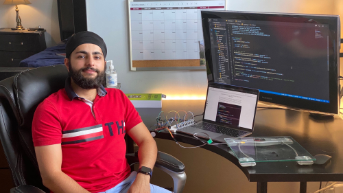 McGill student sits at a computer while he programs a smart-sensor.