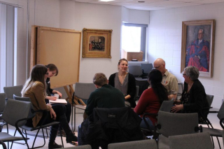 Students, staff and faculty gathered in classroom having a discussion