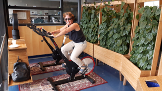 Melanie Fisher on spin bike in Trottier Engineering