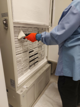 A lab user removes frost buildup from a freezer at the RI-MUHC during the 2023 International Freezer Challenge.