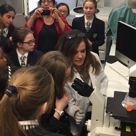 lab manager is demonstrating laboratory equipment to students 