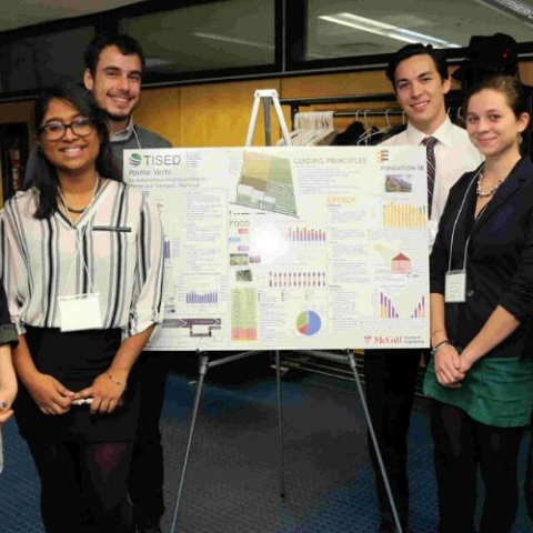 A group of students standing around a poster board