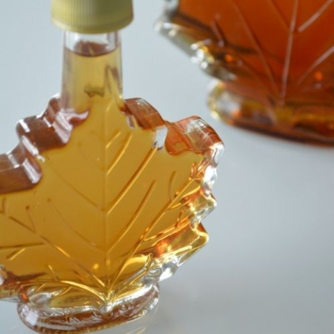 maple leaf shaped bottle with maple syrup within