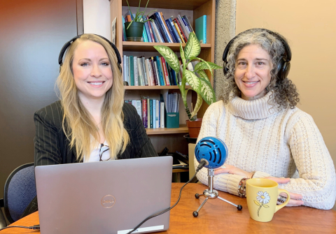 Jasmine Parent and Margo Echenberg sit in front of a laptop and microphone, ready to record a podcast episode