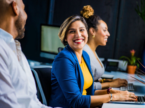 smiling woman on computer 