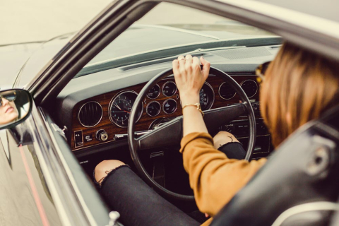 woman holding steering wheel
