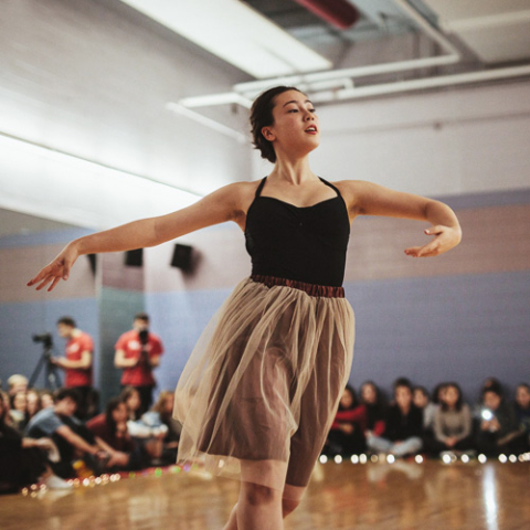 A dancer from the Algeria Dance Club performs in front of an audience