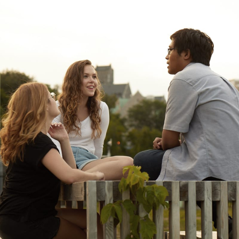 Students talking at a picnic table