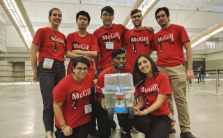 Chemical Engineering students posing together with their prototype for an eco-friendly car design.