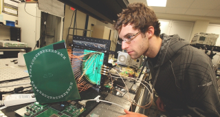A student observing or working on a prototype designed in the lab.