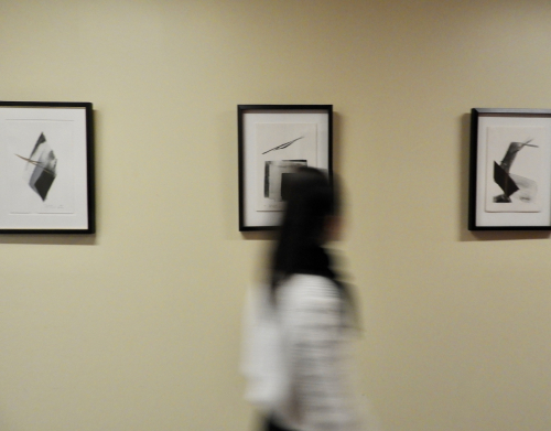 Image of someone walking by the Japanese Prints display in Bronfman.