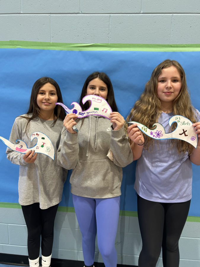 students holding their waves