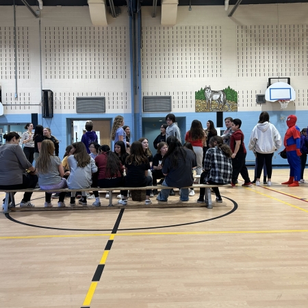 students sitting in the gym