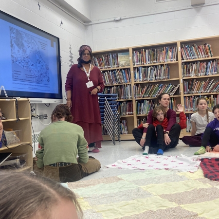 students on floor watching screen