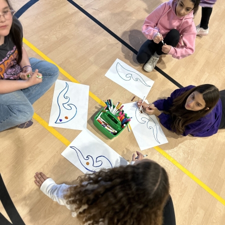 students on floor working on art