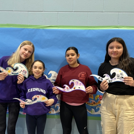 students holding their waves