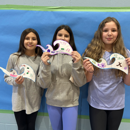 students holding their waves