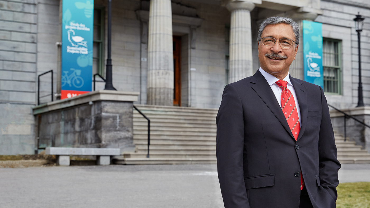 Principal Deep Saini standing in front of the Arts Building on McGill's downtown campus.