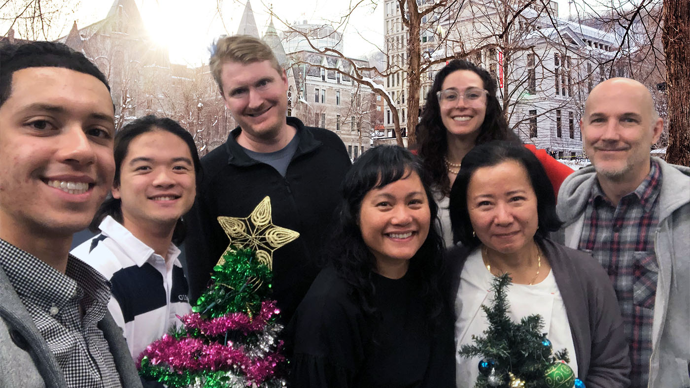 Smiling Web Services unified web team members holding holiday decorations