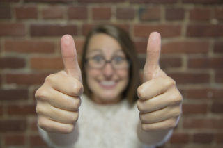 woman with two thumbs up