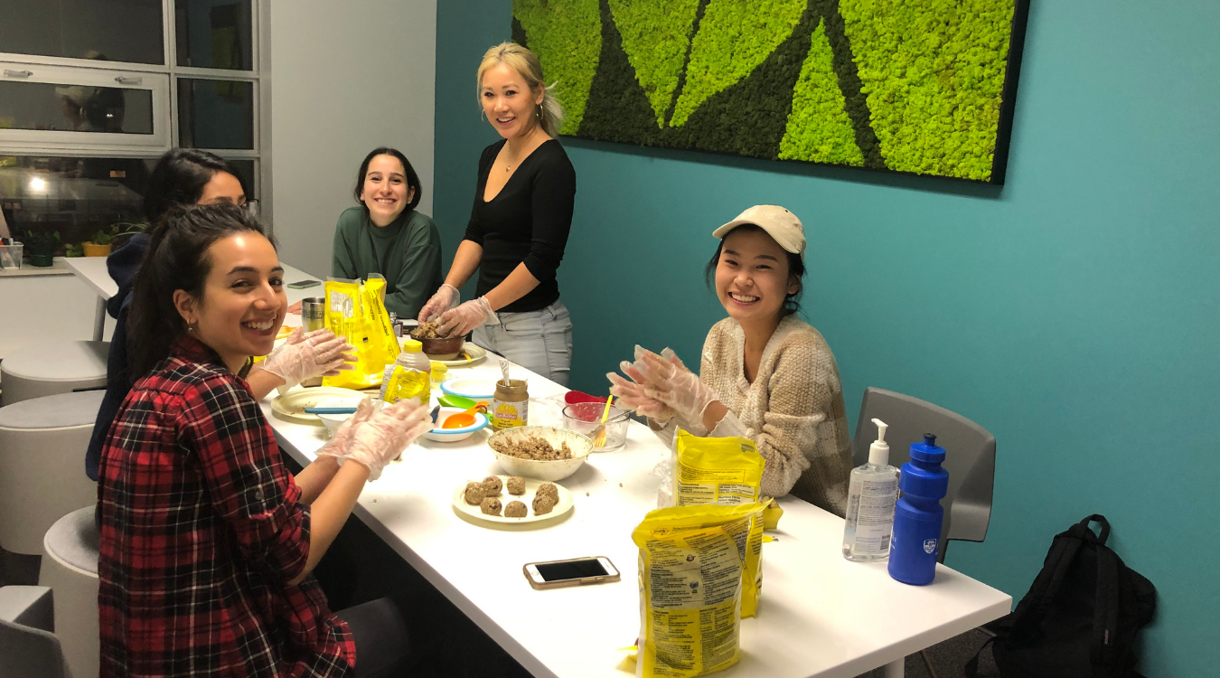 Peer supporters gathered around a table cooking