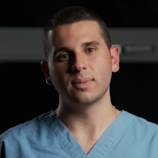 Young man in blue scrubs