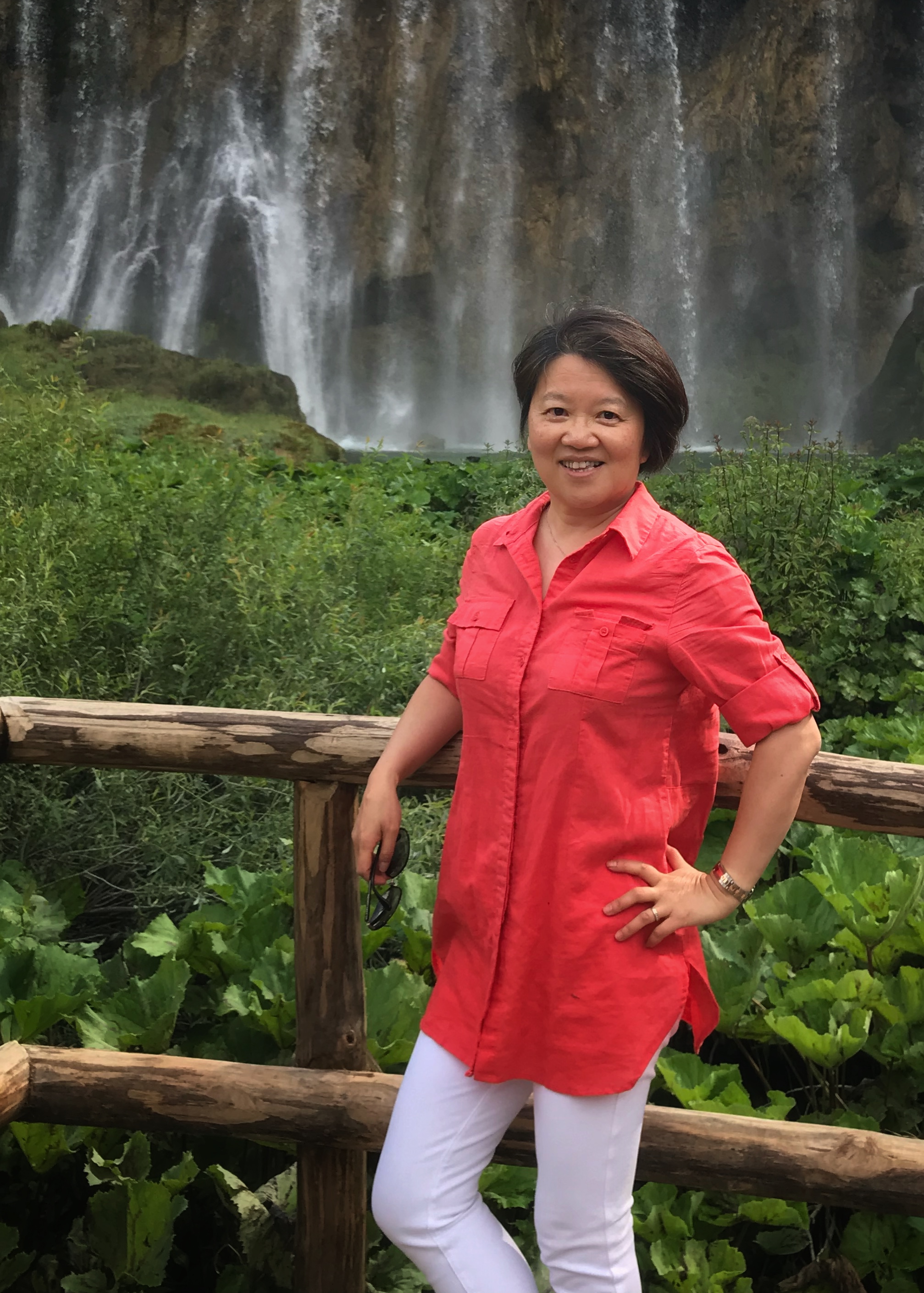  Dr Ji Zhang in a red top in front of a waterfall